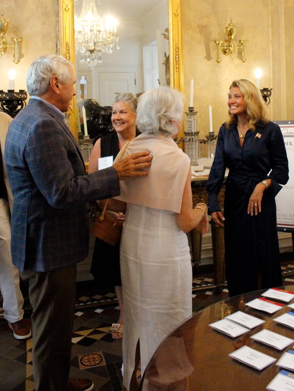 Jenny Costa Honeycutt greeting attendees in a photo attached to the Facebook post.