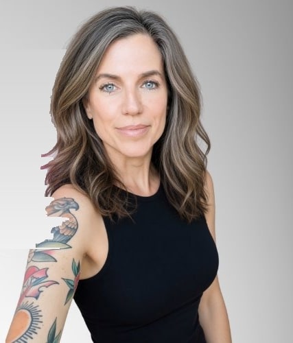Nancy Mace in a black tank top showing her colorful tattoo sleeve on her left arm, a large American-traditional bird on the upper arm with leaves, a rose, and a sun down the forearm. Cropped from the header image on her own X account.