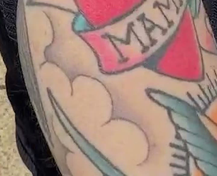 Close-up of stylized American-traditional clouds tattooed on Nancy Mace's forearm, the backdrop the swallow flies through, from TMZ's September 1, 2026 Capitol Hill clip.